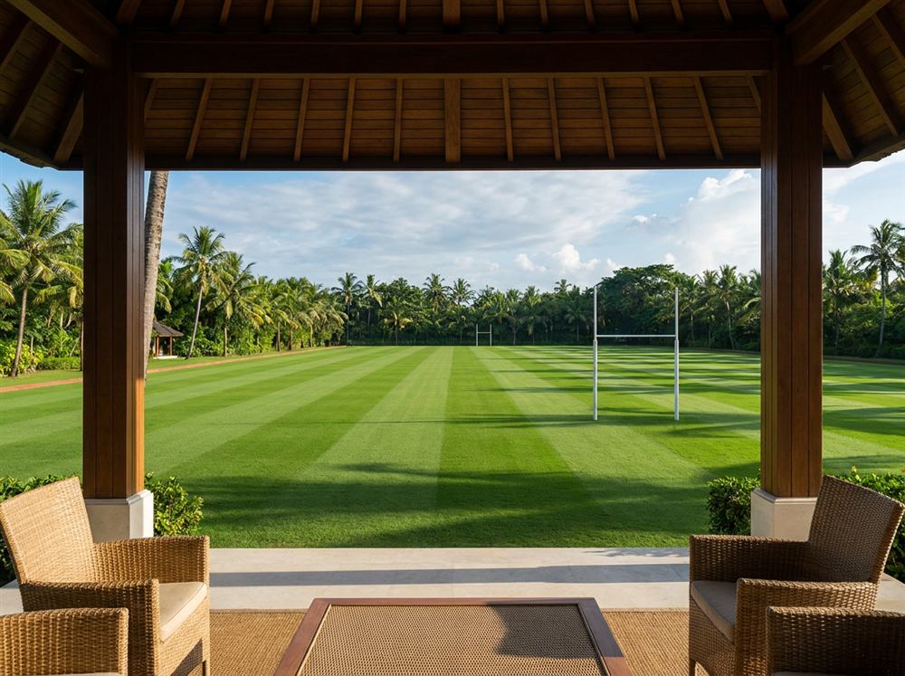 A freshly mown polo field, seen from the shade of a timber pavilion